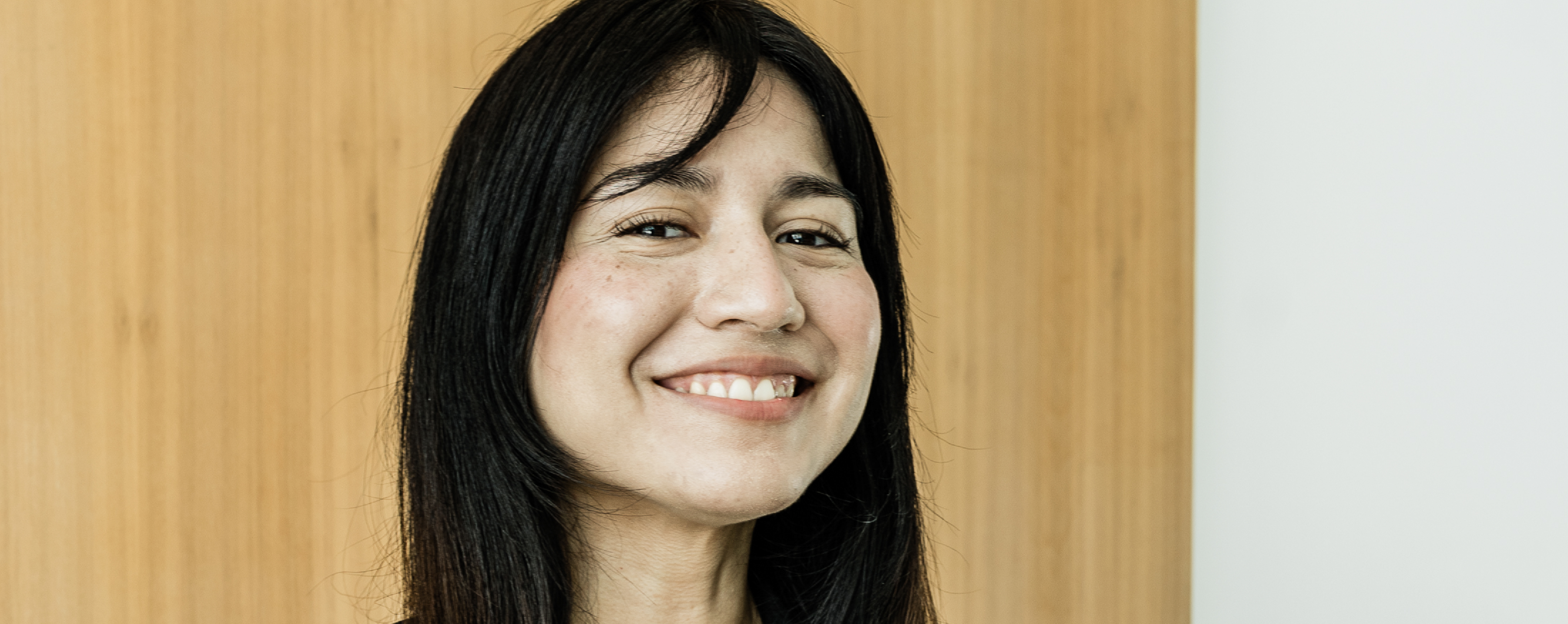 Young professional woman smiling at the camera.
