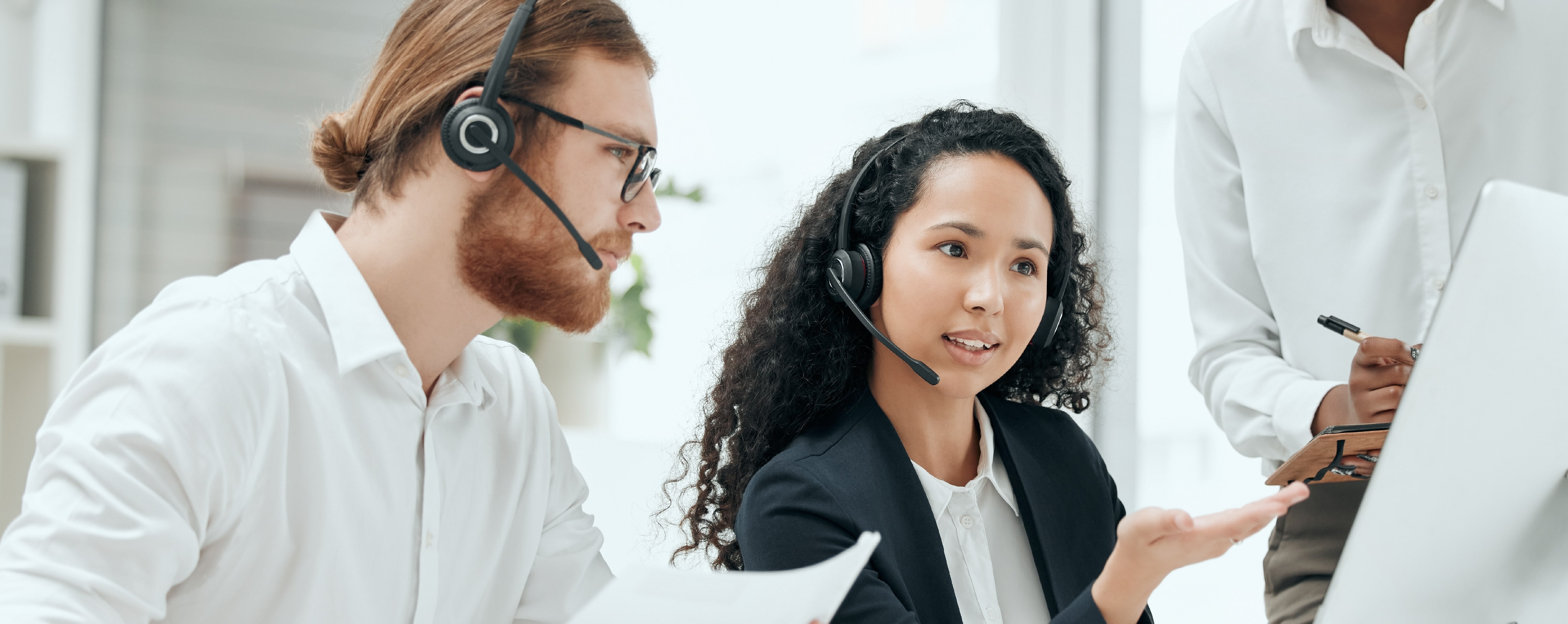 Coworkers collaborating on a project in a contact center.
