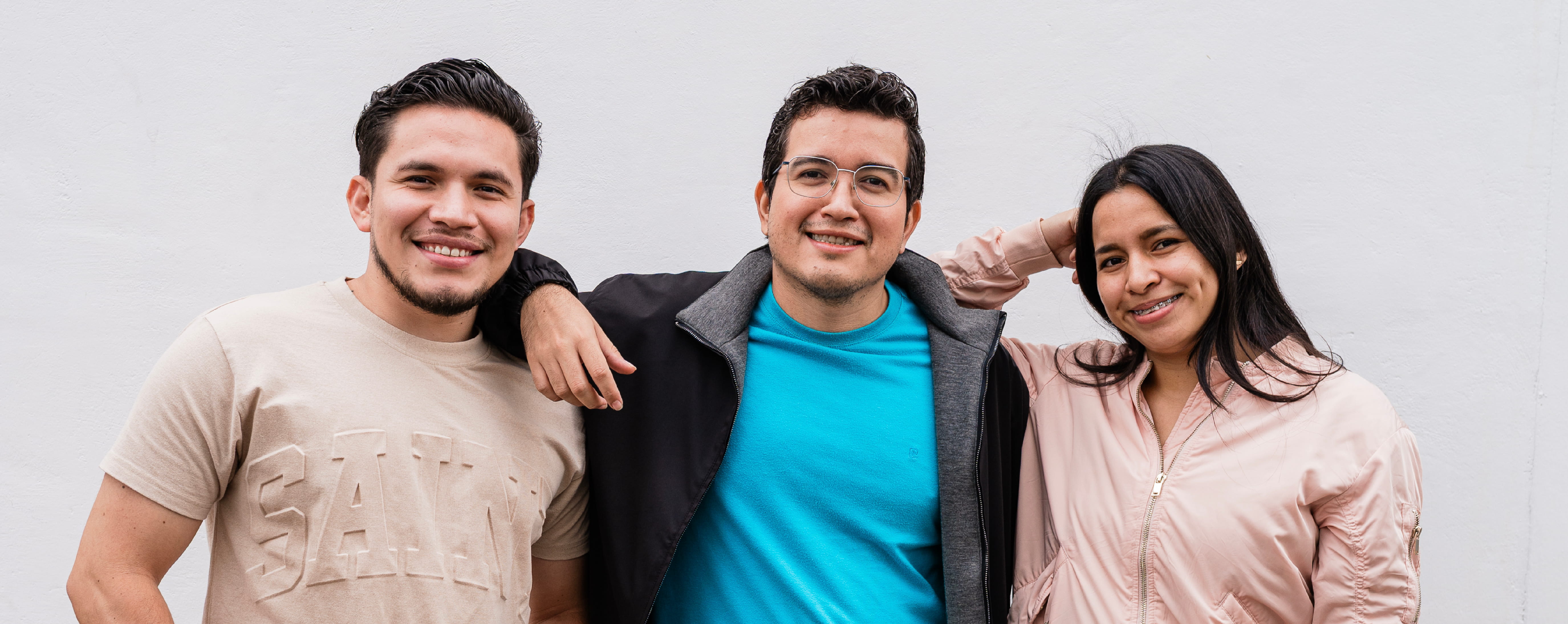 Members of a customer support team smiling at the camera.
