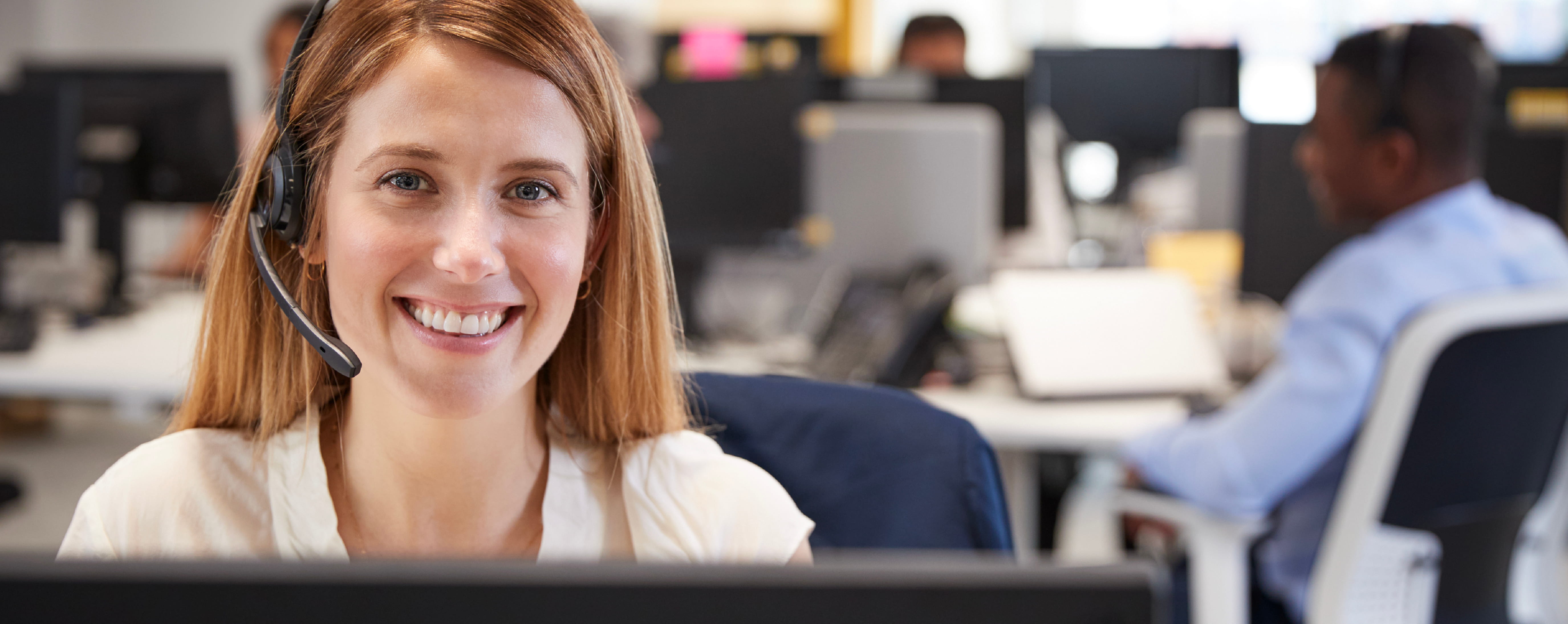 Smiling customer support agent looking at the camera