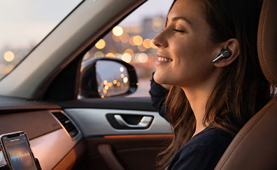 Woman relaxing in her car while listening to online radio through wireless earbuds