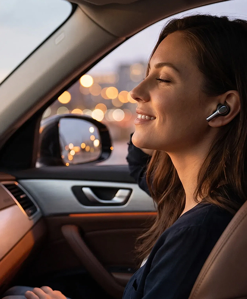 Woman relaxing in her car while listening to online radio through wireless earbuds