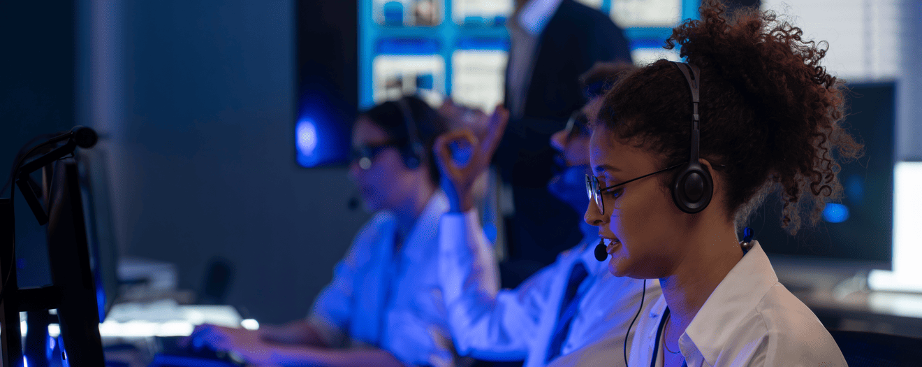 Contact center agents wearing headsets working at their desks