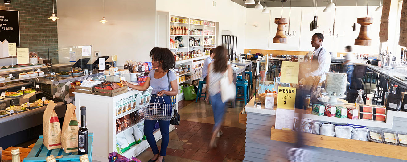 Busy retail store interior with customers shopping and browsing shelves during peak hours