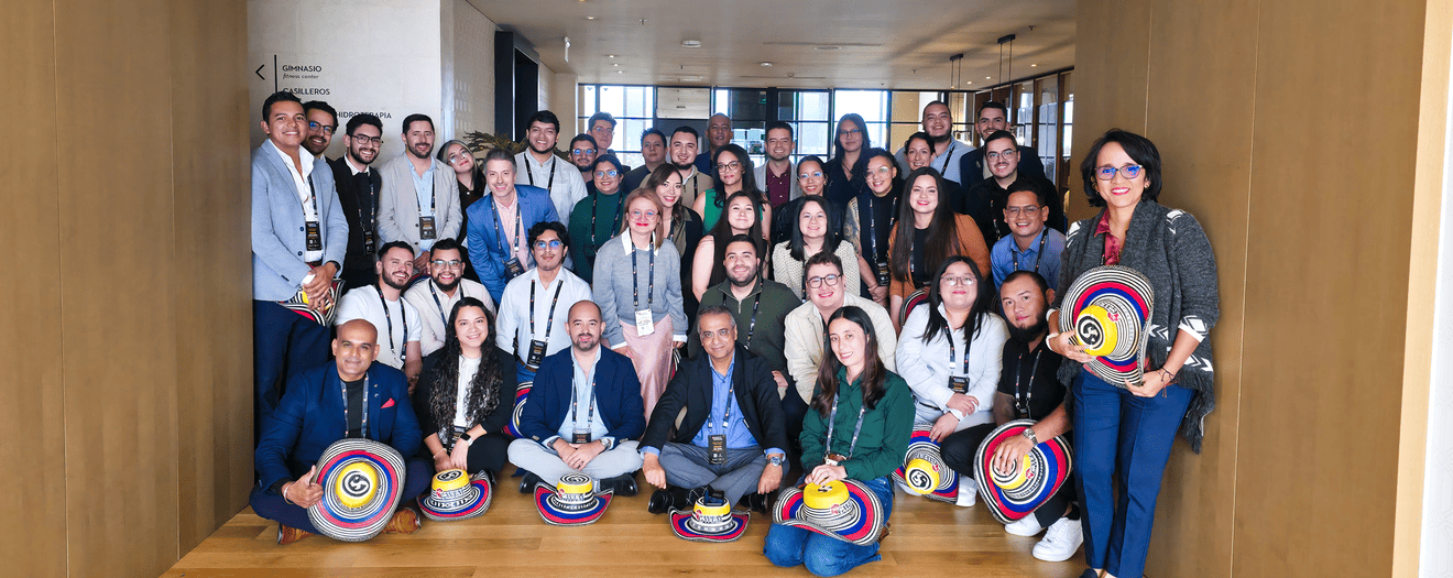 Large group photo of conference attendees posing together indoors